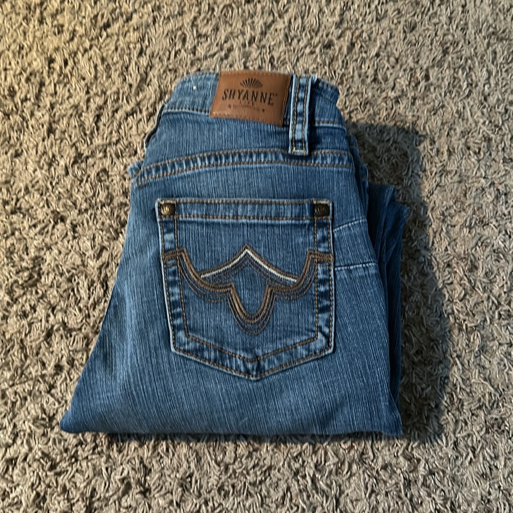 Boot cut jeans, light washed denim, brand is Shyanne. Size 28